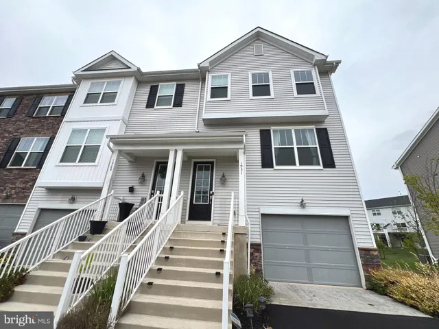 a view of a white house with large windows