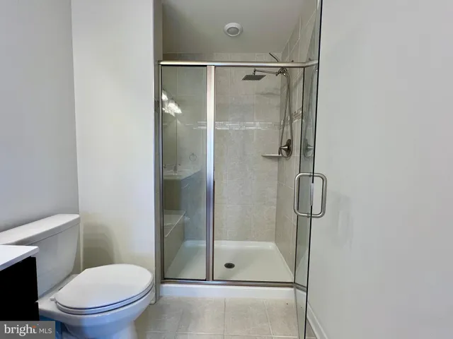 a bathroom with a toilet and a shower