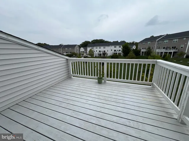 a view of balcony with wooden floor and fence