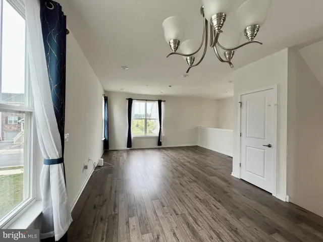 a view of an entryway with wooden floor