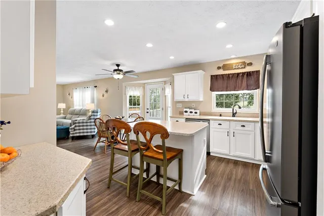 a kitchen with a table chairs refrigerator and cabinets