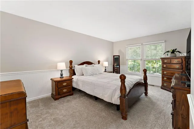 a bed room with a bed and a tv