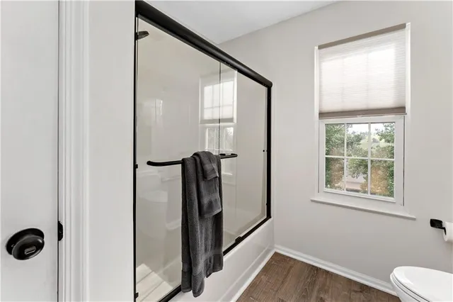 a bathroom with a bathtub and a window