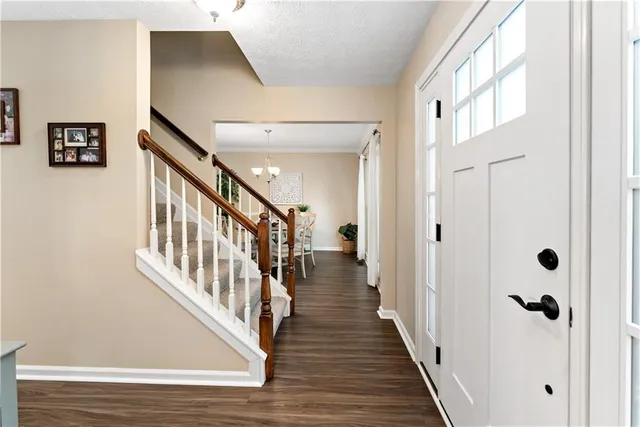 a view of a hallway with wooden floor and staircase
