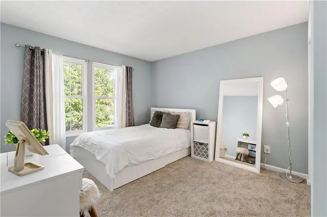 a bedroom with a bed and a table