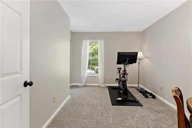 a room with gym equipment and a flat screen tv