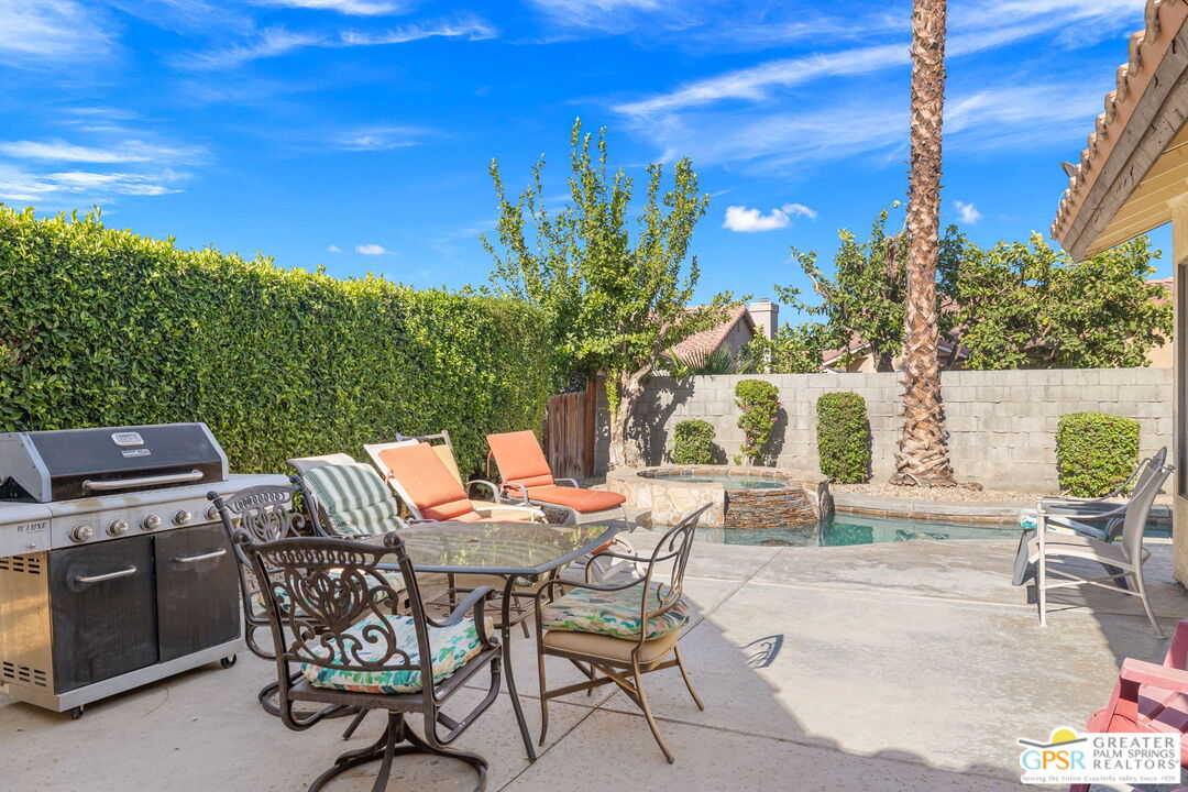 45688 Sutter Creek Road Indio, CA 92201 - Photo 43 of 51 a view of a patio with table and chairs and potted plants