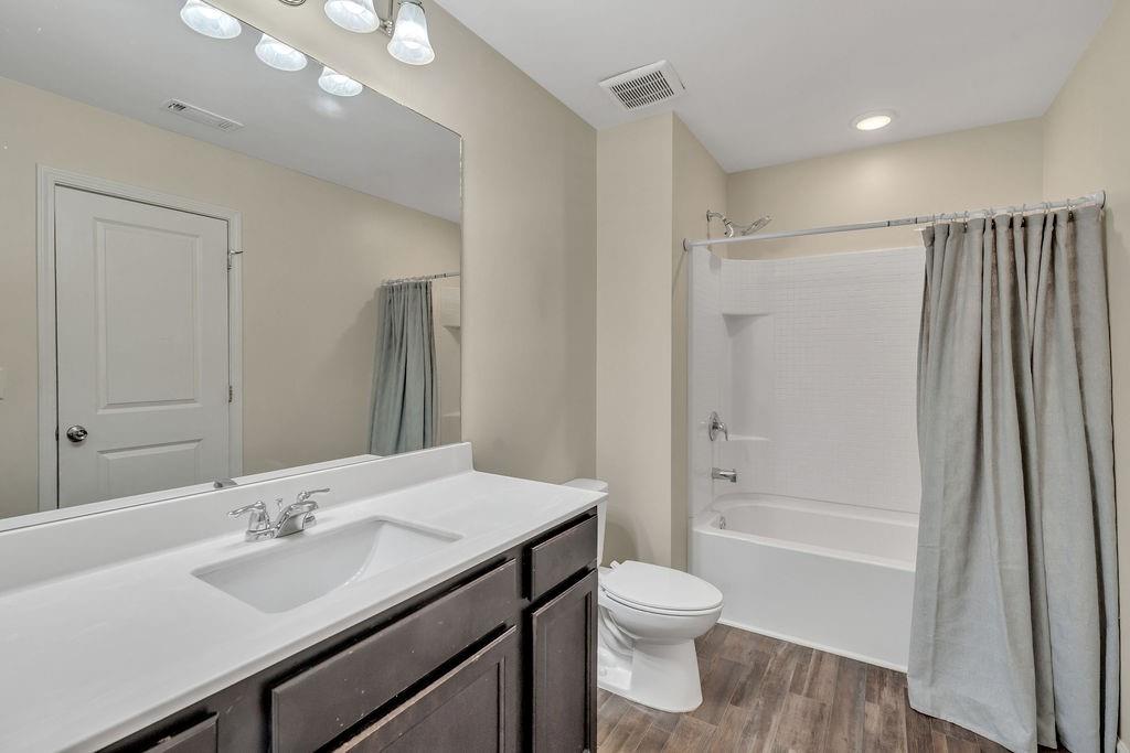 1938 Millstream Hollow Conyers, GA 30012 - Photo 11 of 16 a bathroom with a sink a toilet and shower