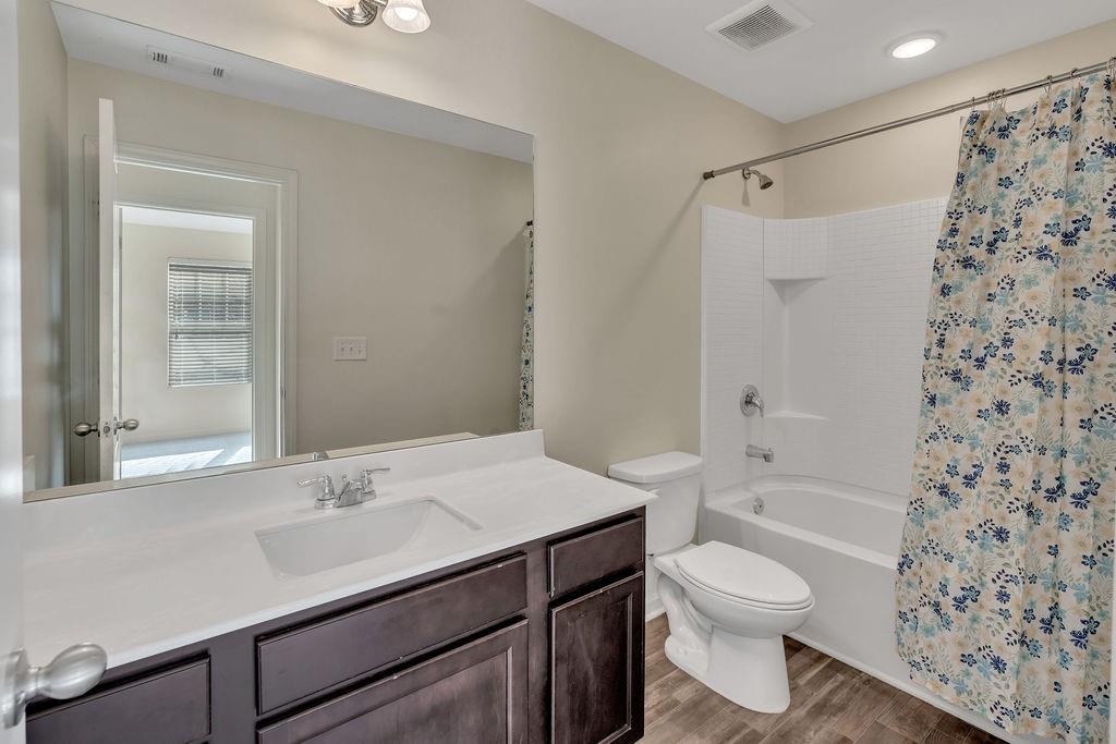 1938 Millstream Hollow Conyers, GA 30012 - Photo 13 of 16 a bathroom with a sink toilet a shower and a mirror