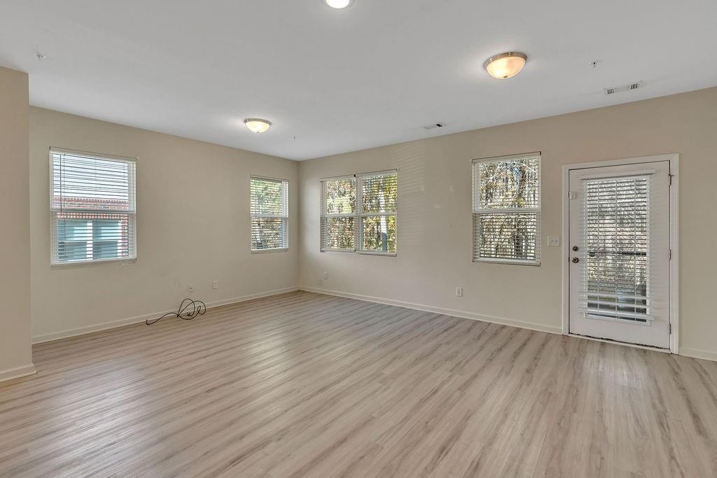 1938 Millstream Hollow Conyers, GA 30012 - Photo 4 of 16 wooden floor in an empty room with a window