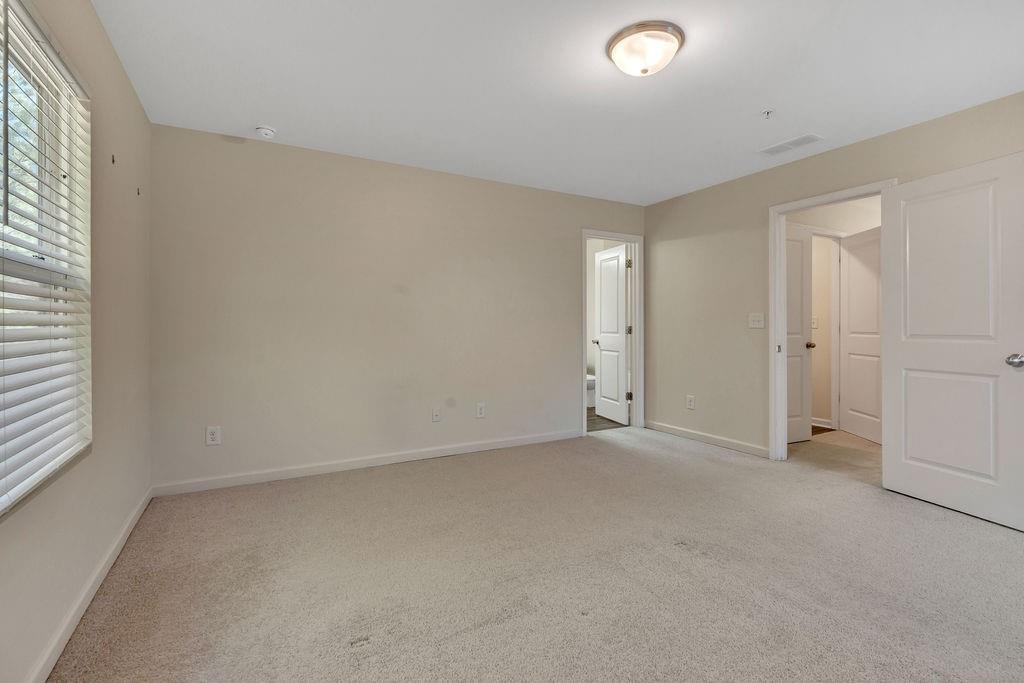 1938 Millstream Hollow Conyers, GA 30012 - Photo 9 of 16 an empty room with a empty space and windows