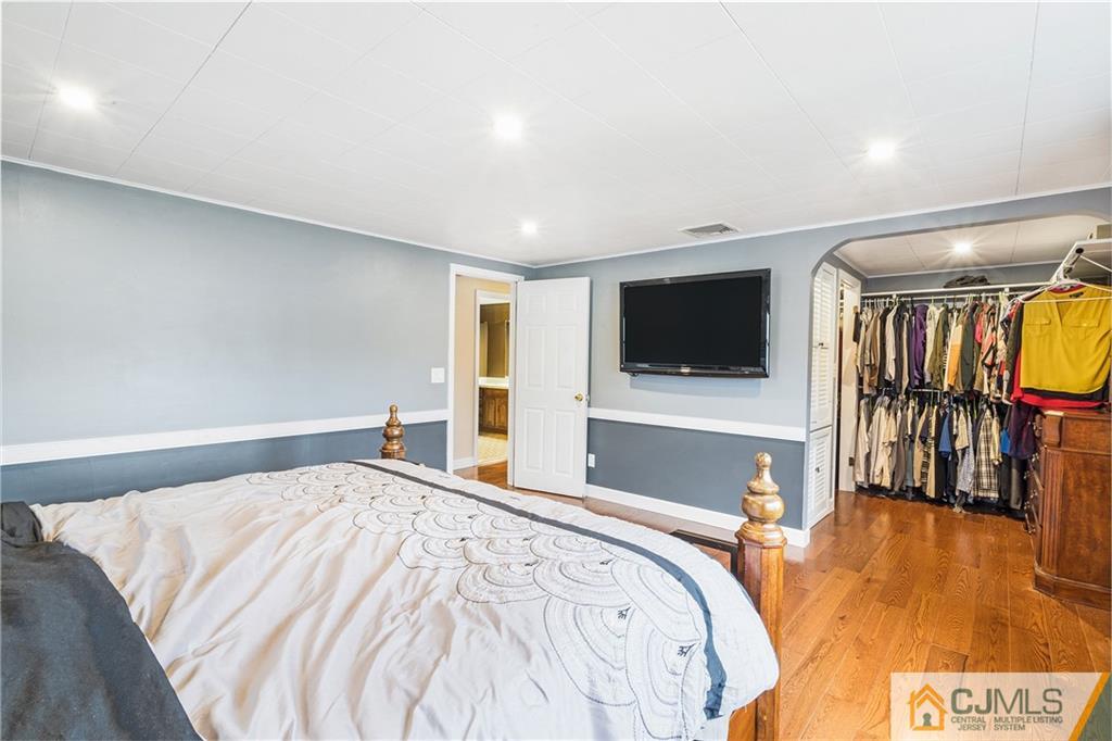151 East Cliff Road Colonia, NJ 07067 - Photo 22 of 29 a bedroom with a bed and a flat screen tv