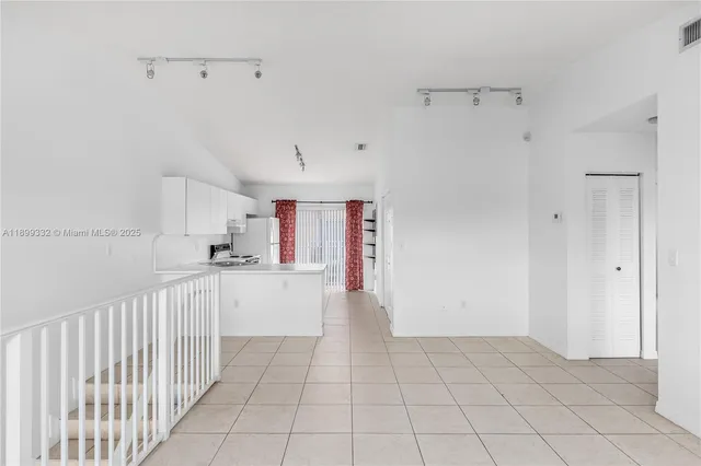 a view of a kitchen with white cabinets