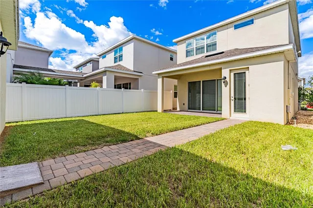 a large kitchen with stainless steel appliances kitchen island a sink and a refrigerator