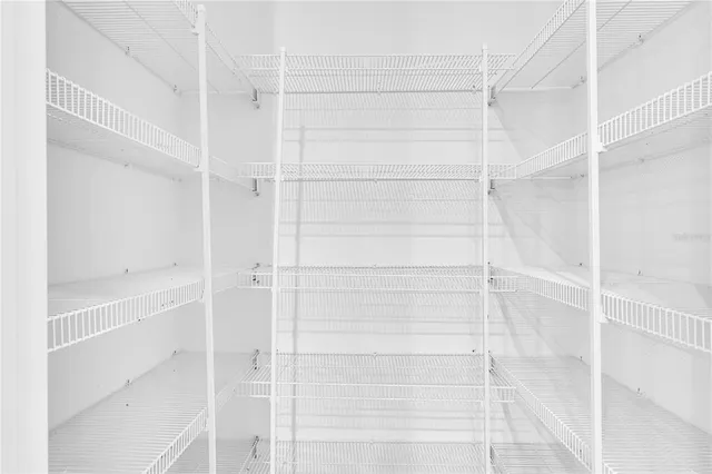 a large kitchen with cabinets and wooden floor