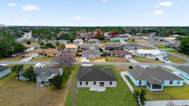 a view of a dining room and livingroom with furniture wooden floor a chandelier