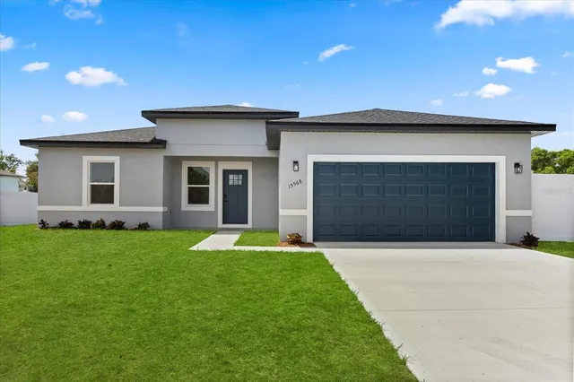 a view of kitchen with stainless steel appliances kitchen island granite countertop a dining table chairs and a refrigerator