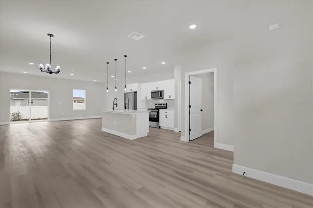 a view of a room with wooden floor and window