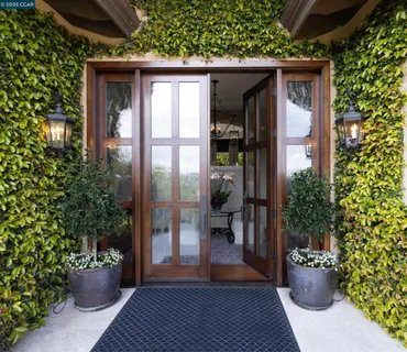 a view of a path along with potted plants and wooden fence