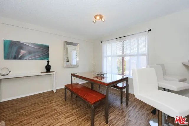 a living room with furniture a window and wooden floor