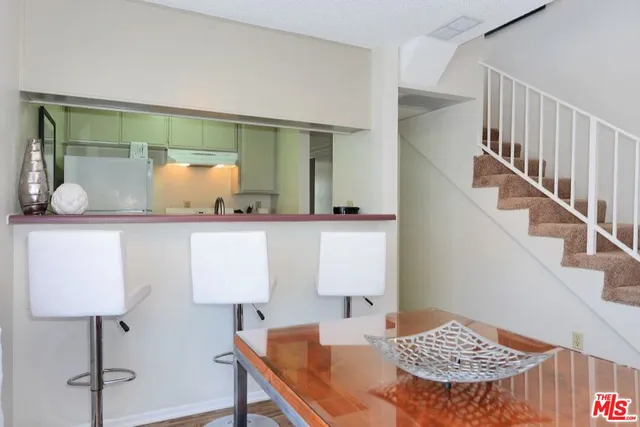 a kitchen with a refrigerator and a stove top oven