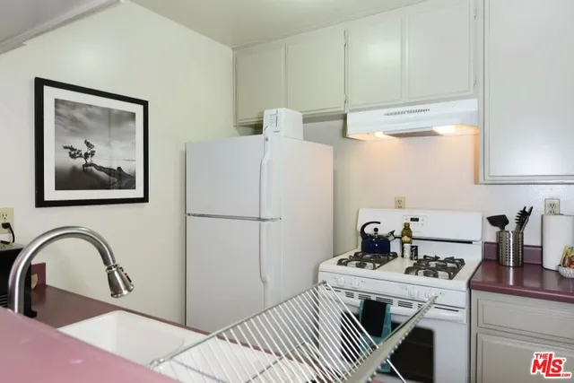 a kitchen that has a sink and a stove in it