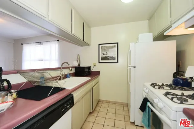 a kitchen with stainless steel appliances a stove a sink and a refrigerator