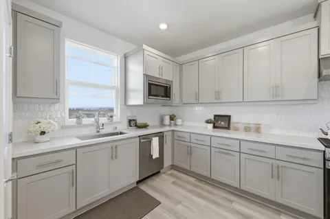 a kitchen with a sink stove and cabinets