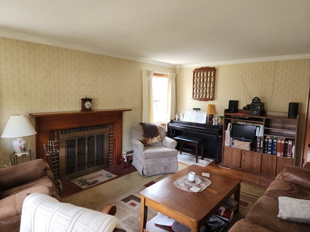 946 Bradley Road Springfield, MA 01109 - Photo 11 of 16 a living room with furniture and a fireplace