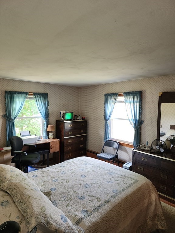 946 Bradley Road Springfield, MA 01109 - Photo 12 of 16 a bedroom with a bed and a window