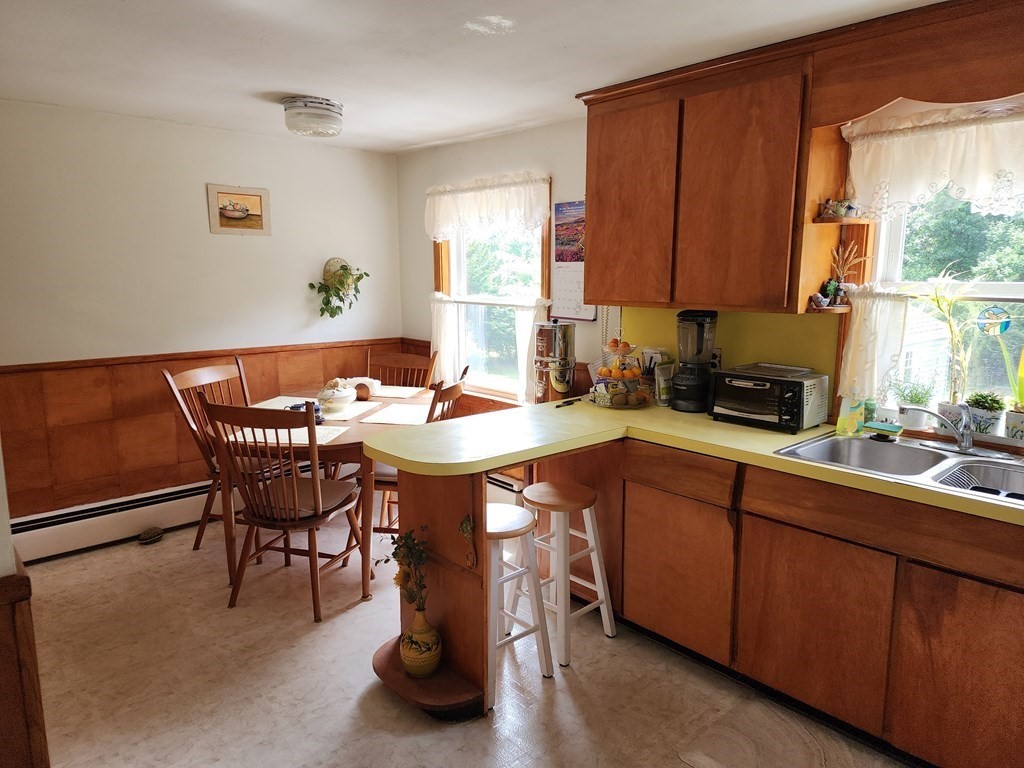 946 Bradley Road Springfield, MA 01109 - Photo 8 of 16 a kitchen with a sink table and chairs