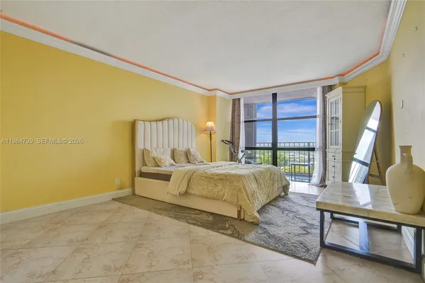 a bedroom with a bed and a large window