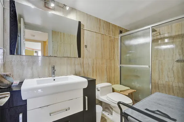 a open kitchen with stainless steel appliances granite countertop a refrigerator and a sink