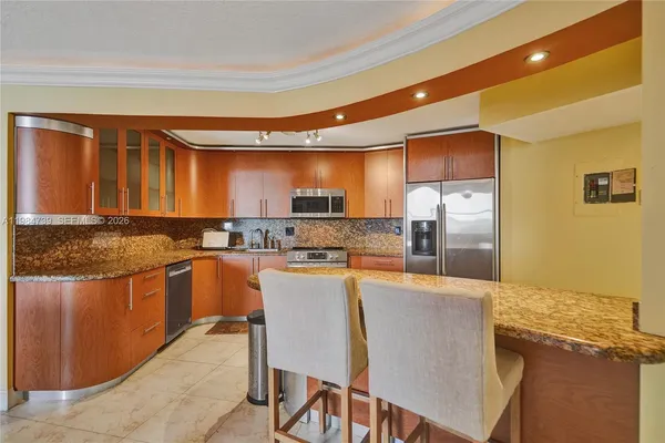 a kitchen with stainless steel appliances granite countertop a sink stove and microwave