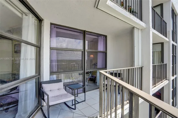 a view of staircase with furniture and a window