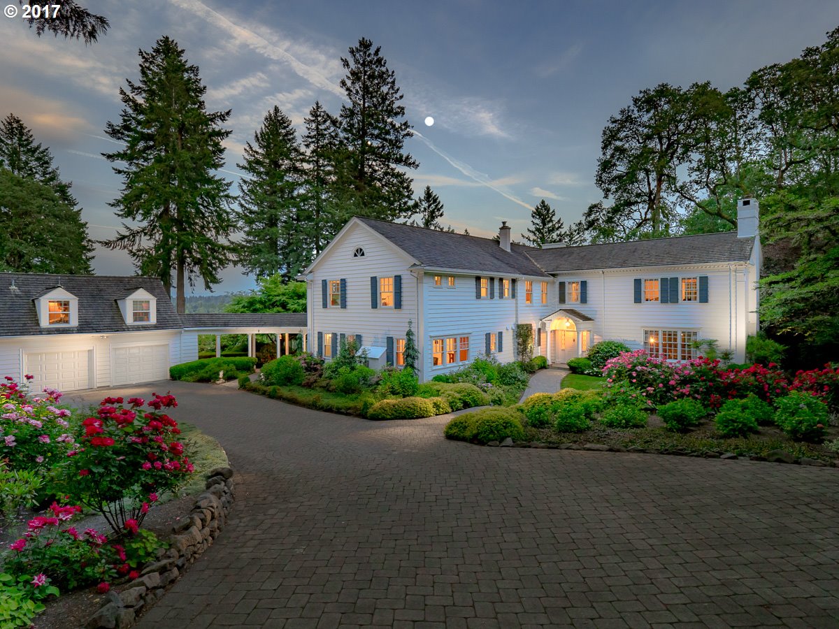 a front view of a house with a yard and a garden