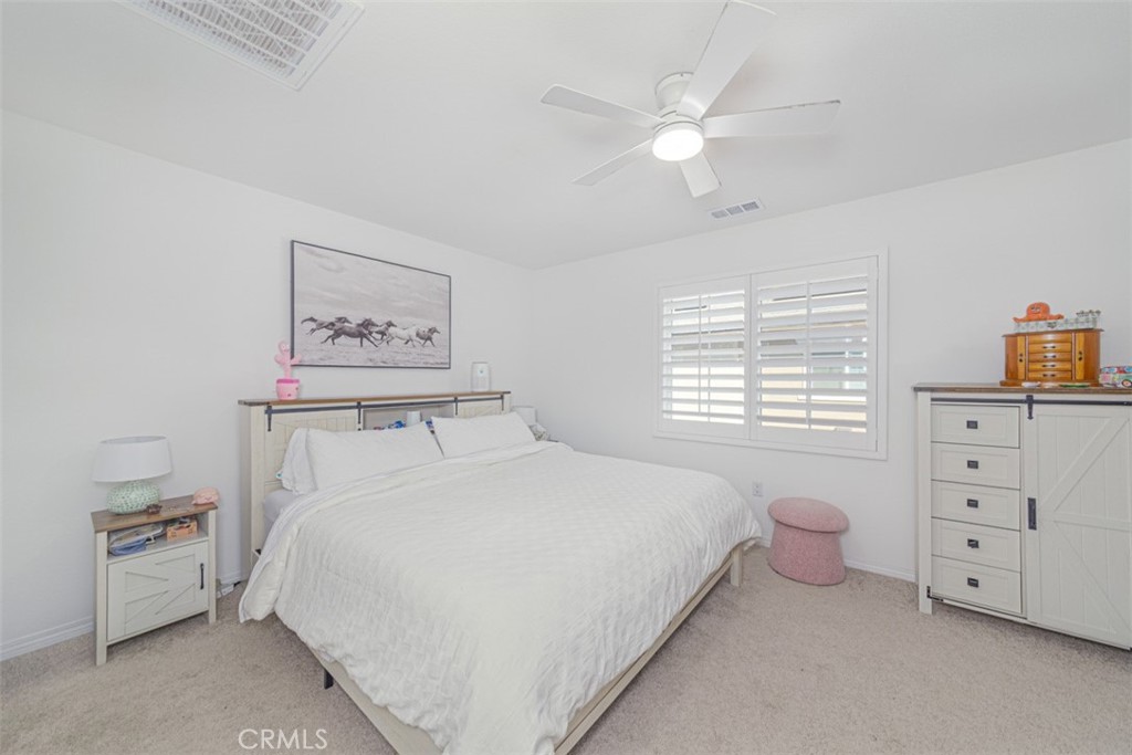 7395 Olive Grv Street Riverside, CA 92507 - Photo 13 of 18 Spacious primary room uptairs with ceiling fan and plantation shutters.