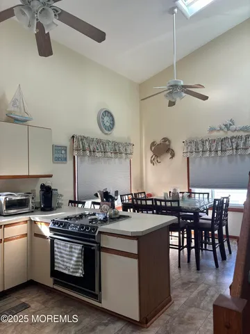 a kitchen with a sink a stove and chairs