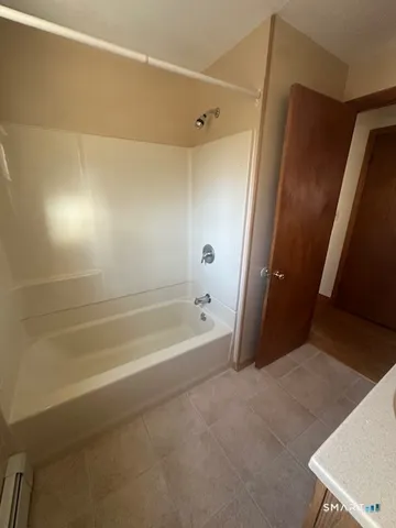a spacious bathroom with a bathtub and a shower