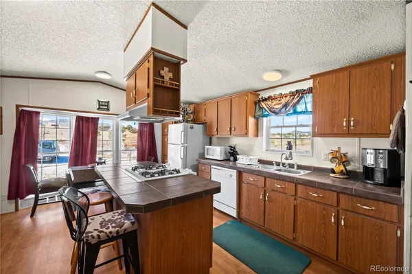 a kitchen with a sink a stove and cabinets