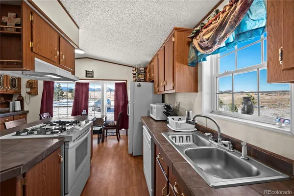 a kitchen with a refrigerator sink and cabinets