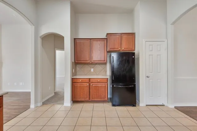a kitchen with stainless steel appliances granite countertop a refrigerator and a refrigerator
