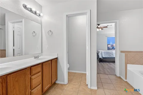 a en suite bathroom with a sink and a mirror