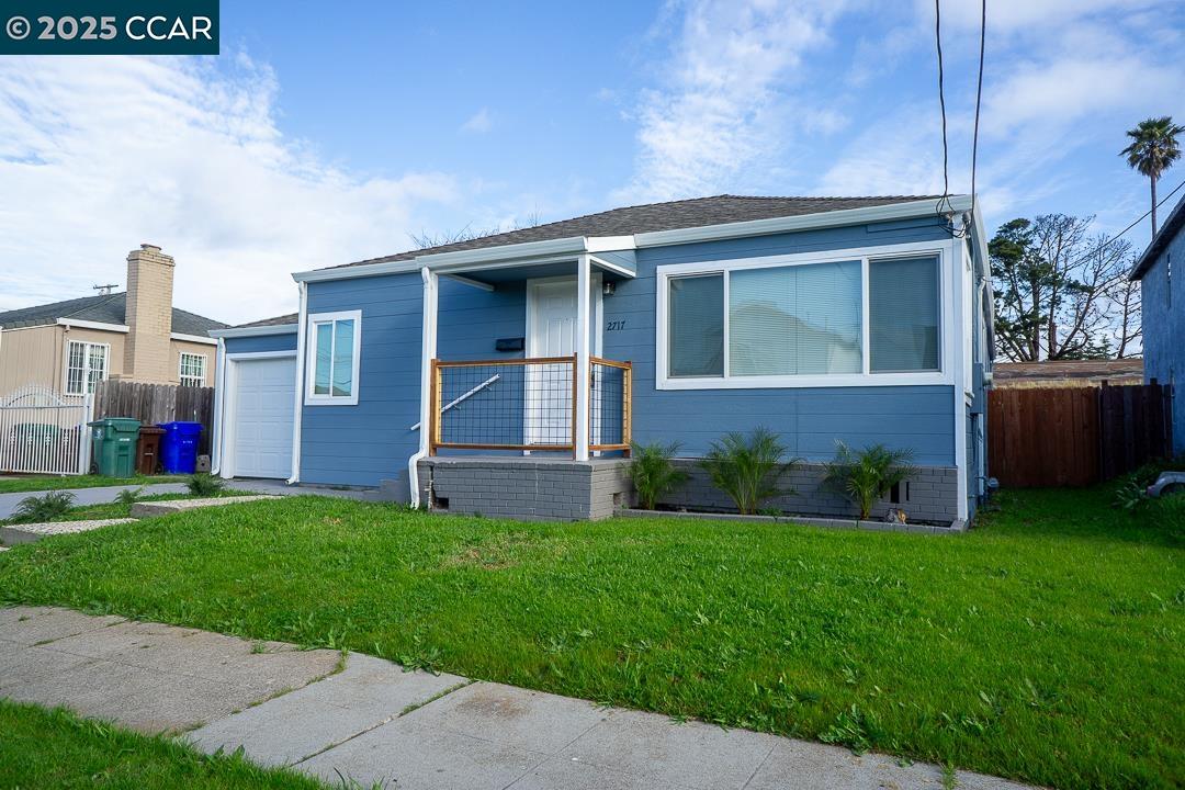 2717 Center Avenue Richmond, CA 94804 - Photo 1 of 1 a front view of a house with a yard and garage