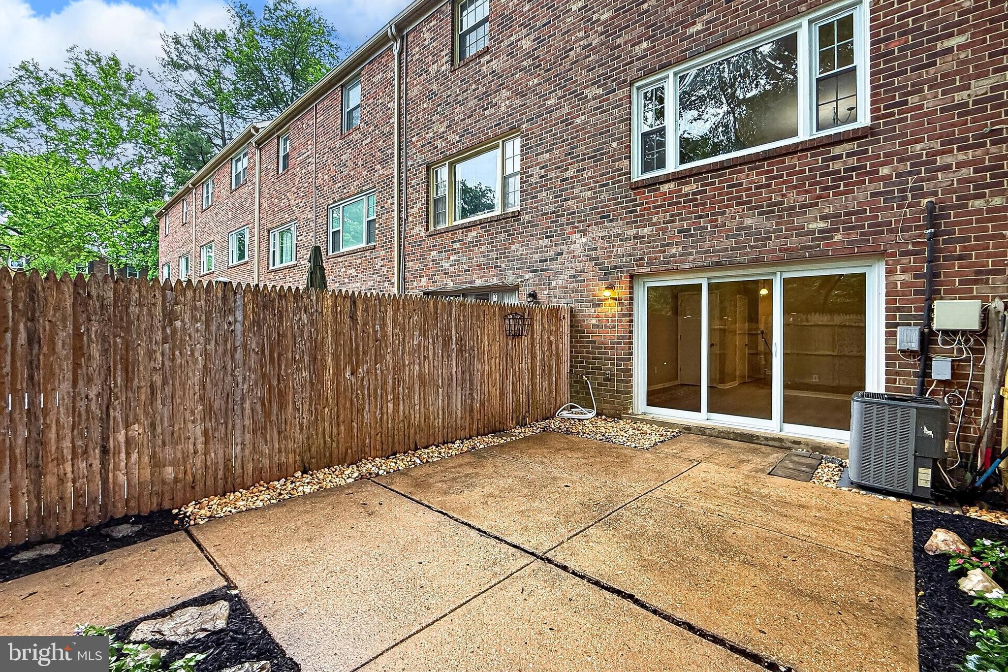 5833 Royal Ridge Drive, Unit 943 Springfield, VA 22152 - Photo 41 of 45 a view of a house with a wooden bench
