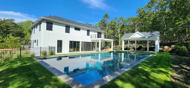a view of house with a yard