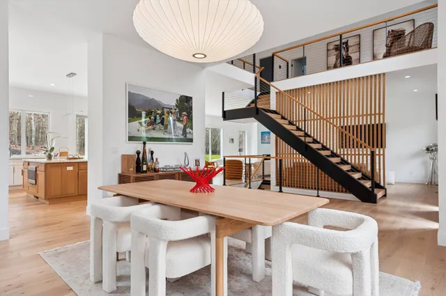 a dining room with furniture and a kitchen view
