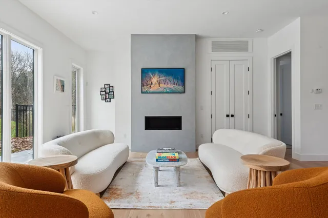 a living room with furniture a rug and a fireplace