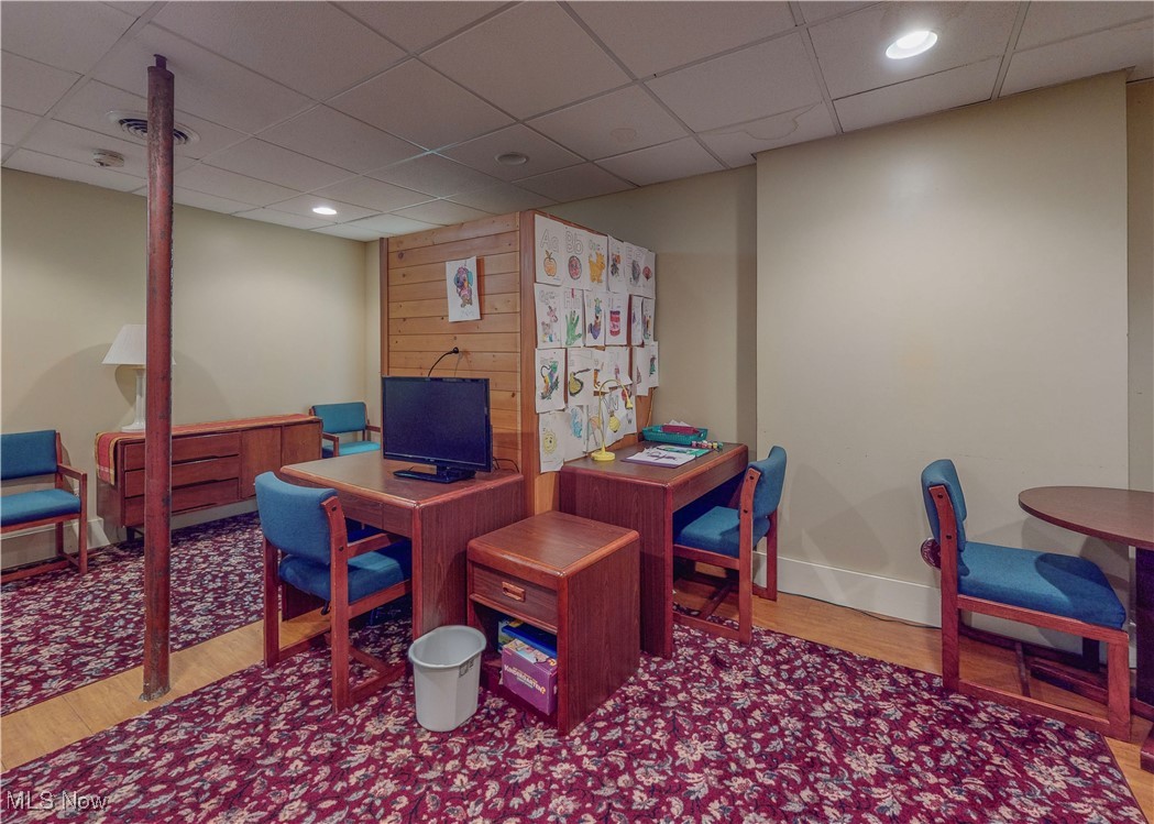 5696 Steubenville Road Southeast Amsterdam, OH 43903 - Photo 27 of 50 Office area featuring a paneled ceiling, wood-type flooring, and wooden walls