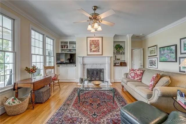 a living room with furniture fireplace and window